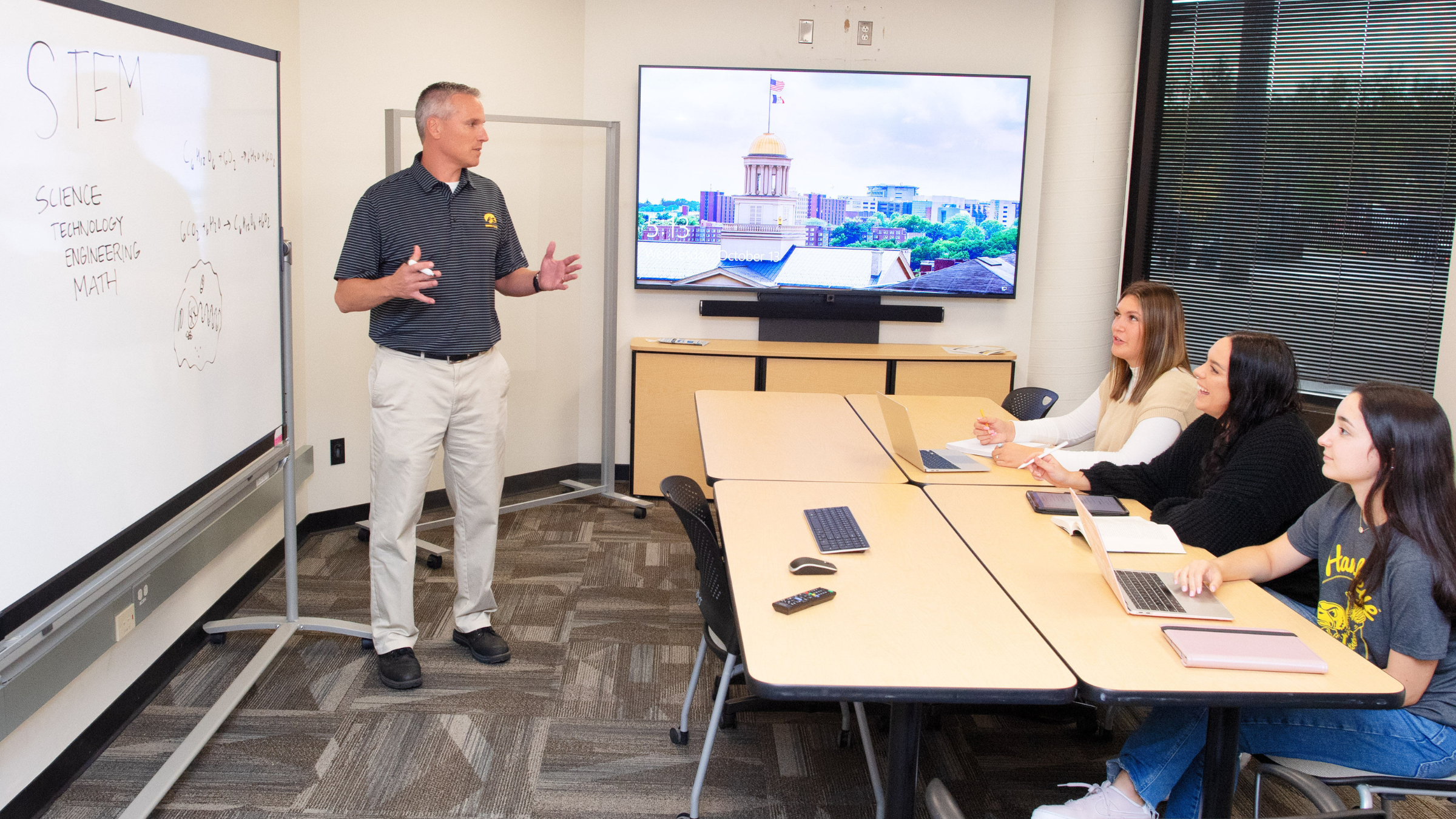 Professor teaching three students