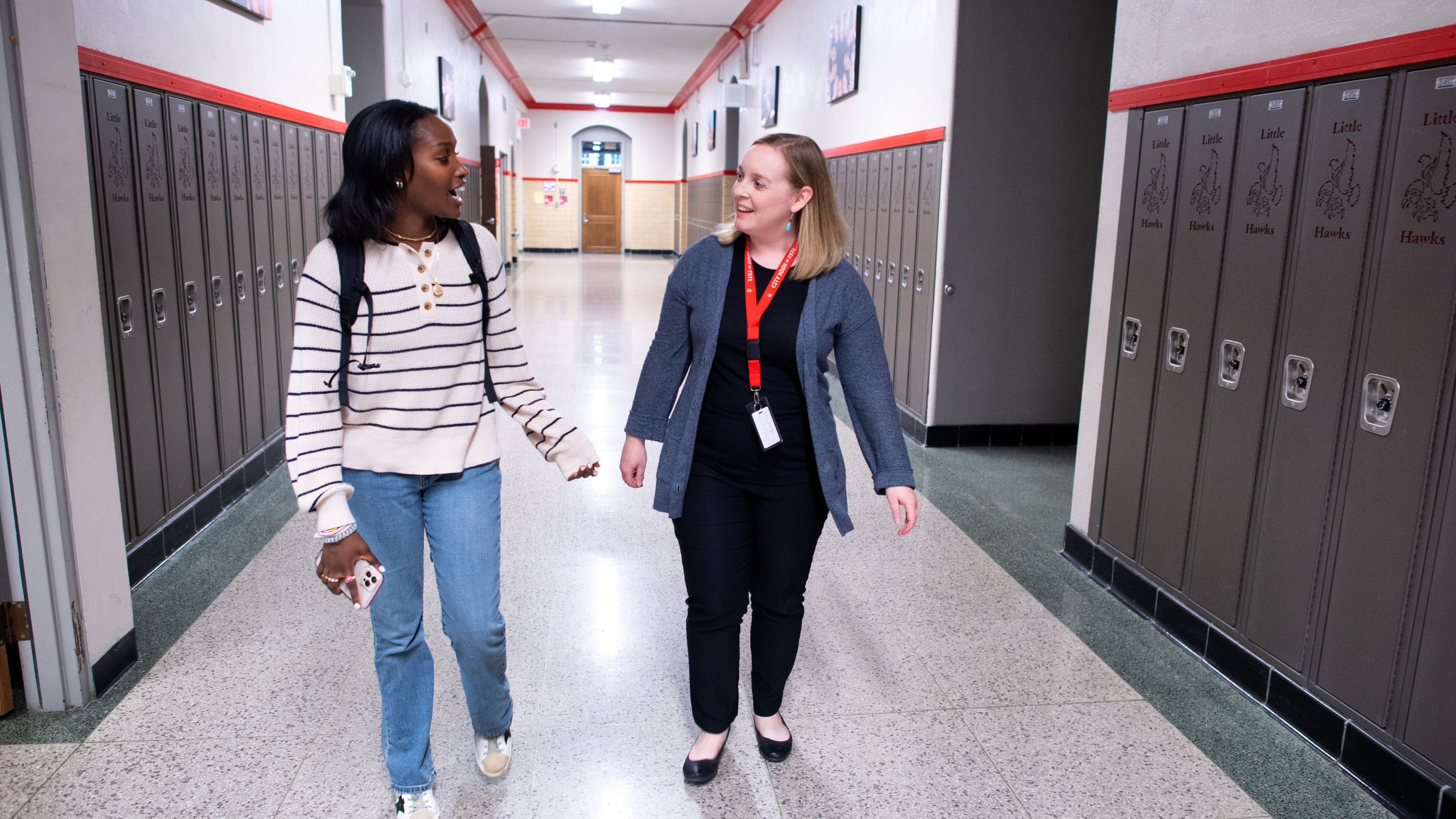 Student and Teacher Walking Down Hallway