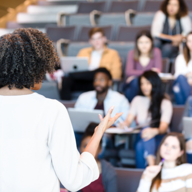 woman standing at front of classroom