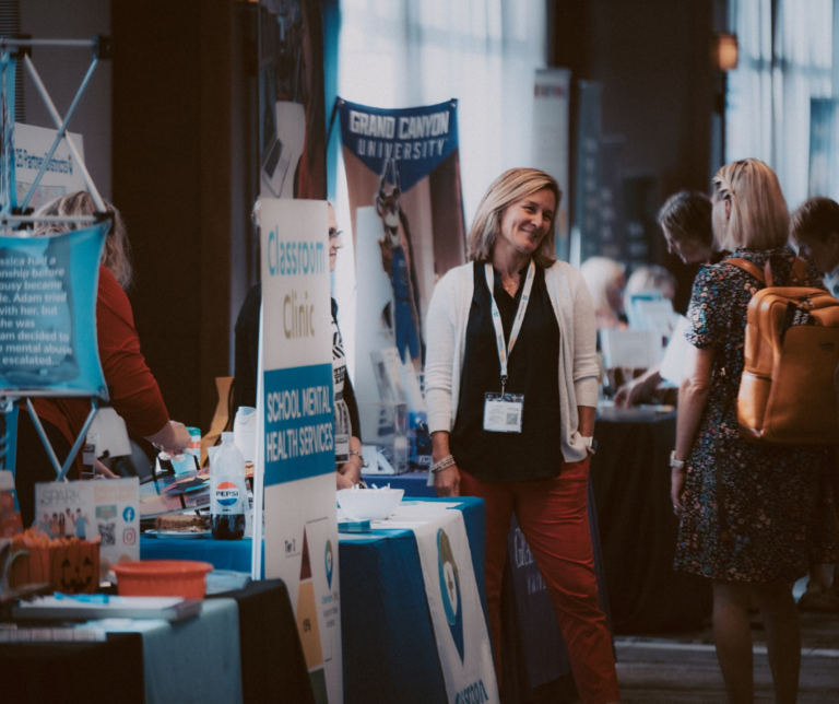 woman talking at exhibitor booth