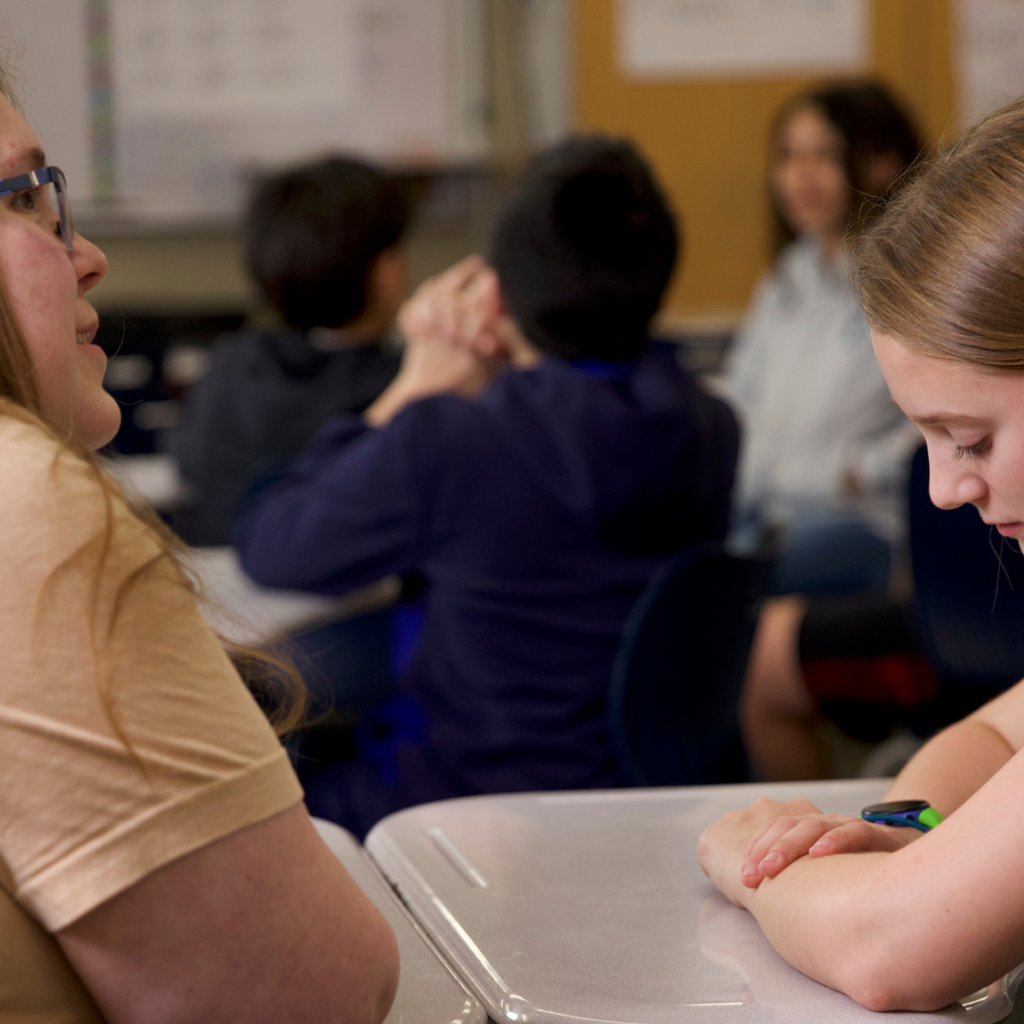 student and teacher talking