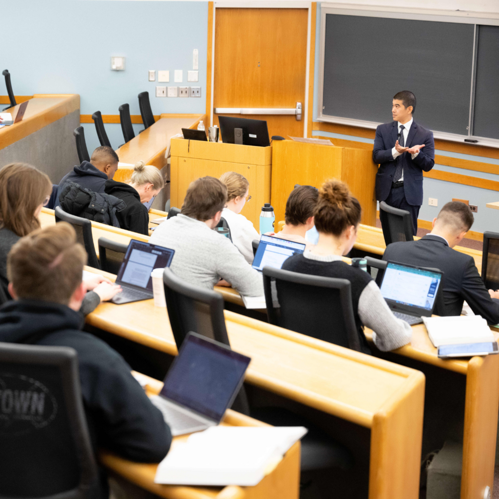 man presenting at front of room