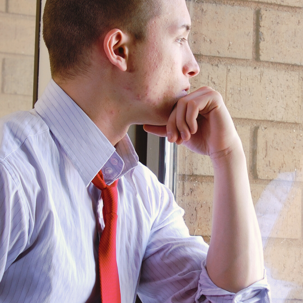 Man looking out window