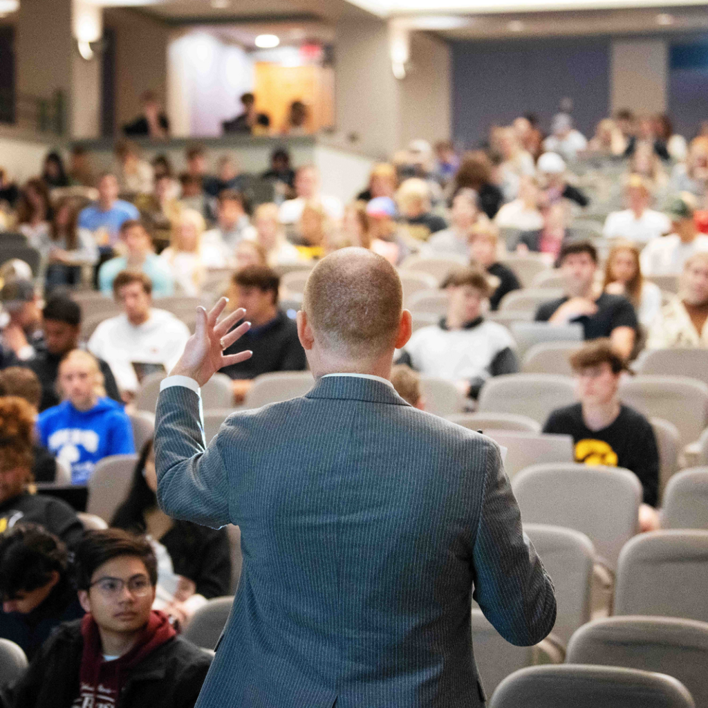 man presenting at front of room