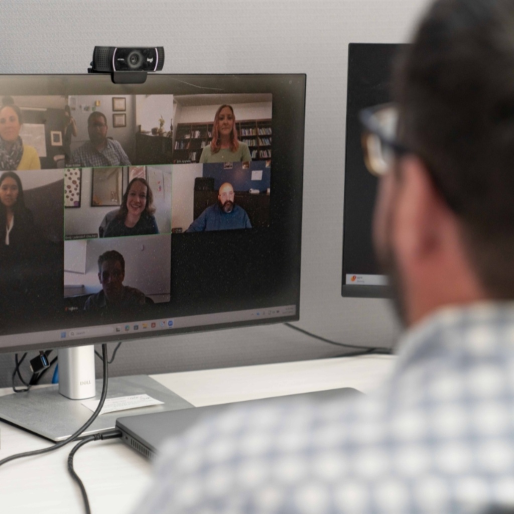 Clinician facilitating an online group counseling session with 6 people on the screen