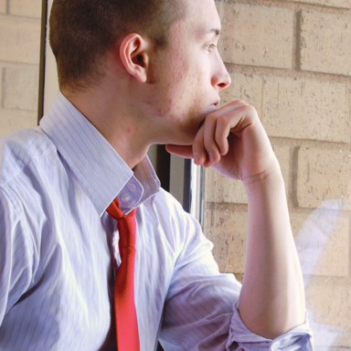 Man looking out window