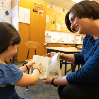 Teacher reading to student