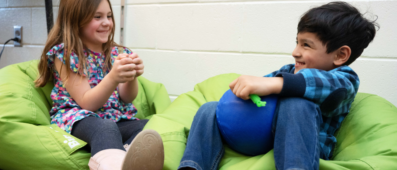 Two kids talking at school