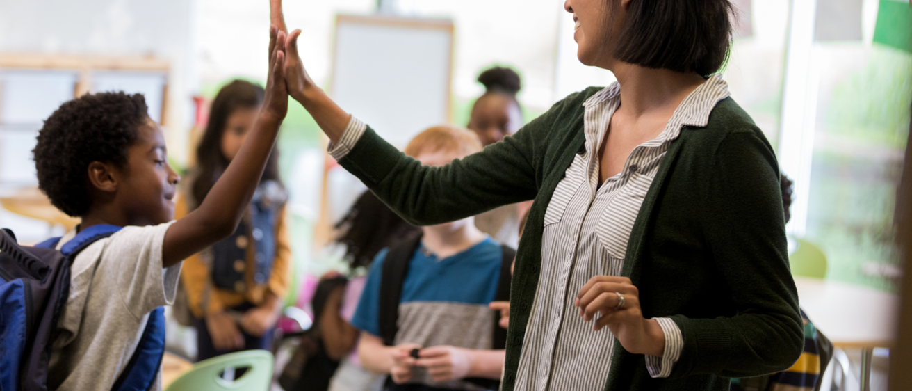 teacher high-fiving student
