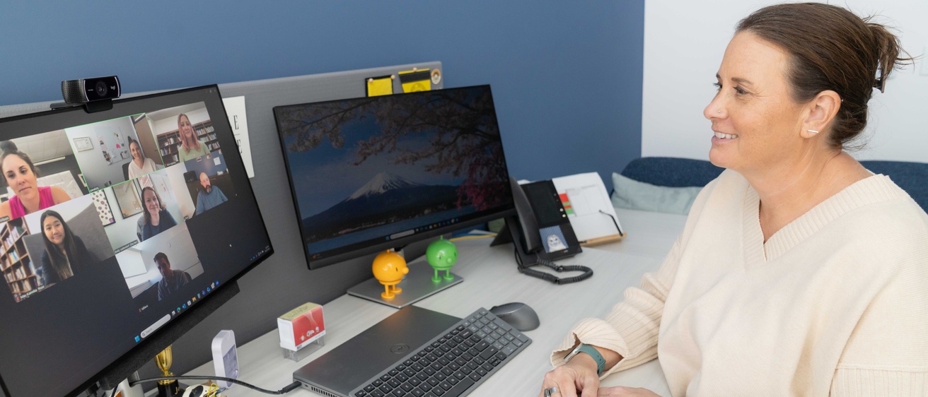Clinician facilitating an online group counseling session with 6 people on the screen