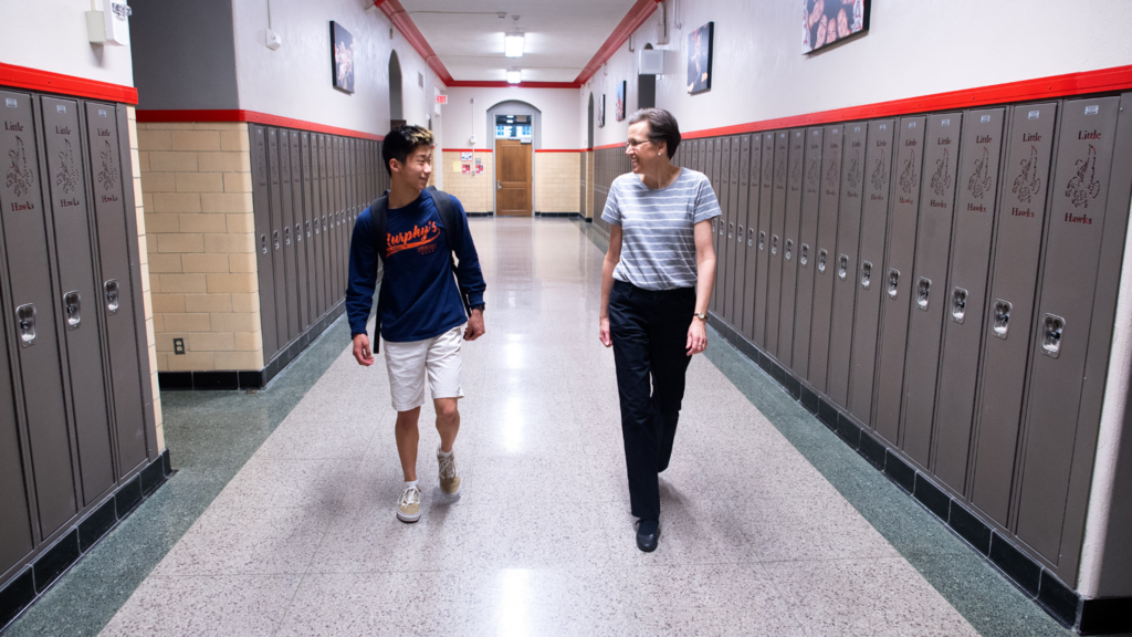 teacher and student walking down hallway