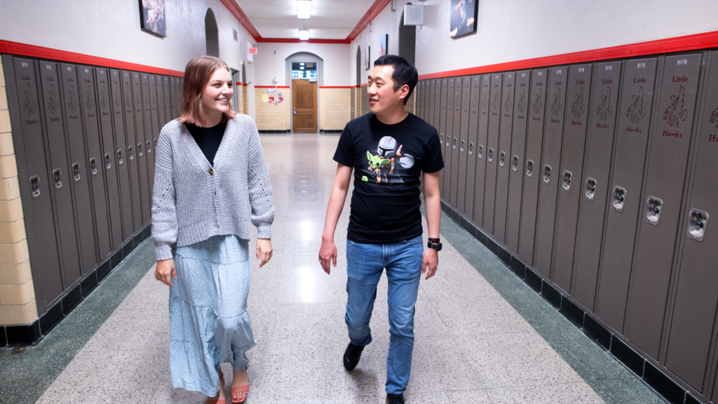 teacher and student walking down hallway