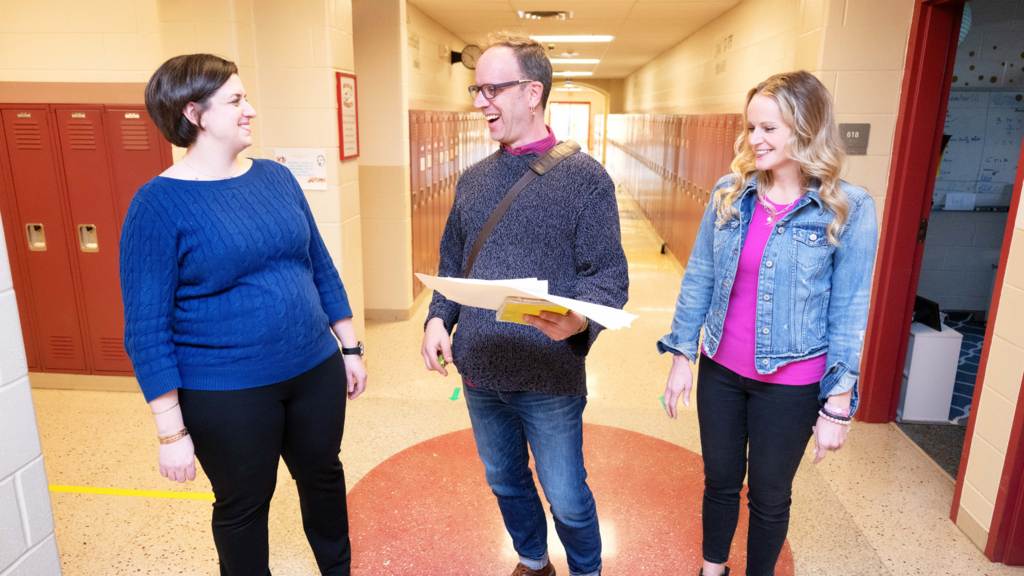 three teachers talking in hallway