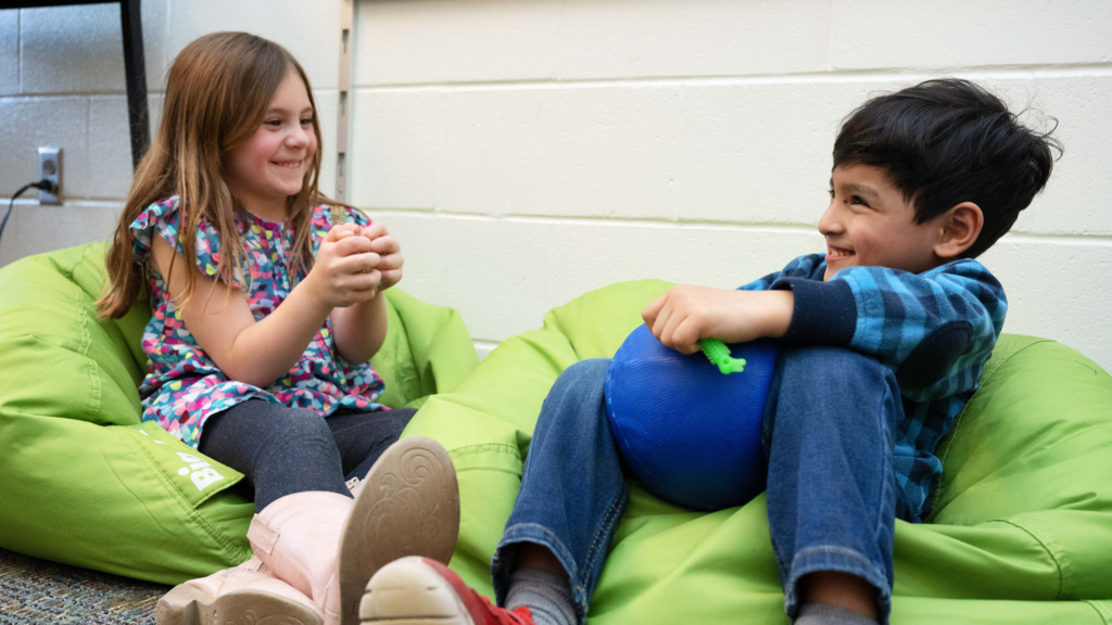 Two kids talking at school