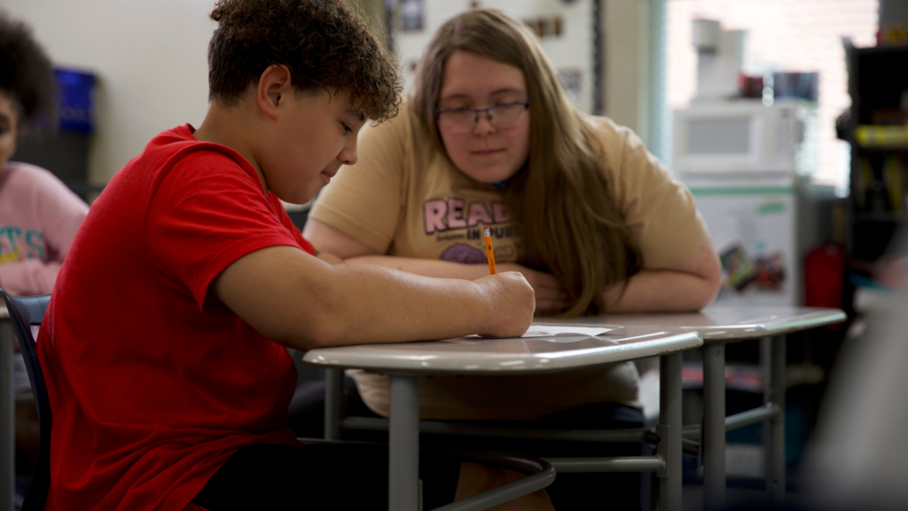 Teacher helping student