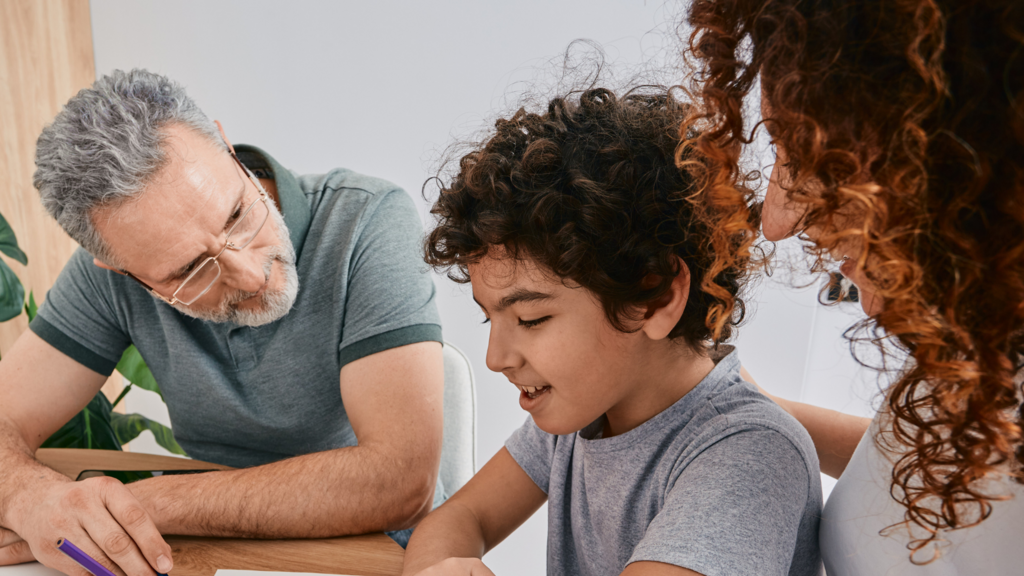Two parents helping a child