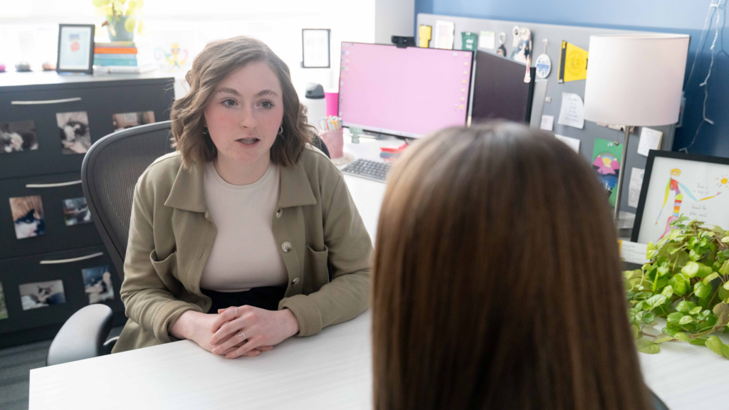 Adult talking with a student