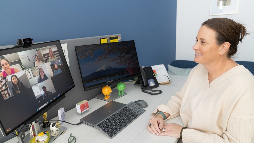 Clinician facilitating an online group counseling session with 6 people on the screen