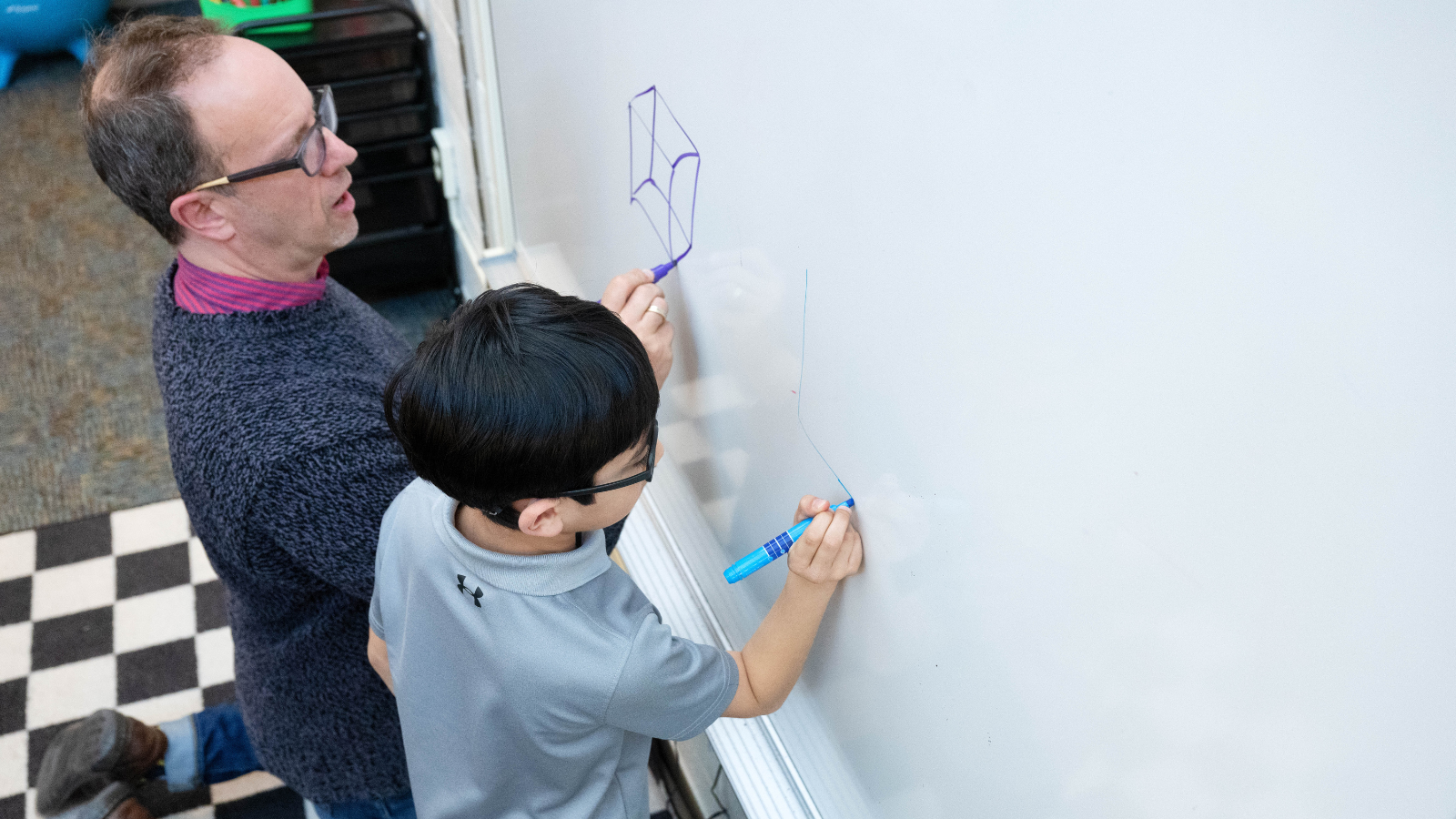 Teacher and student at whiteboard
