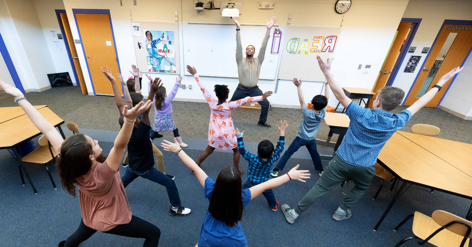 Teacher stretching with students