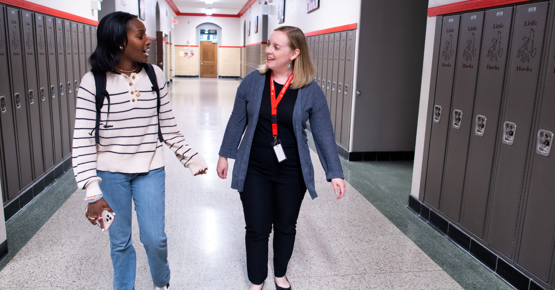 Teacher and student walking down hallway