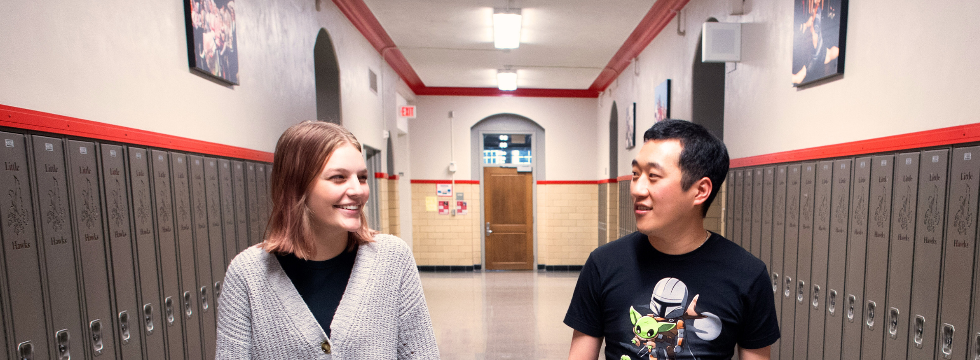 student and teacher walking in hallway