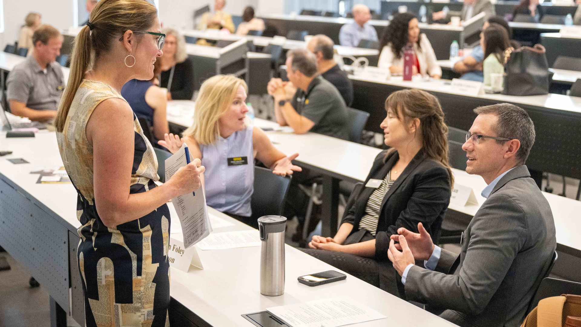 Group of adults sitting at classroom tables