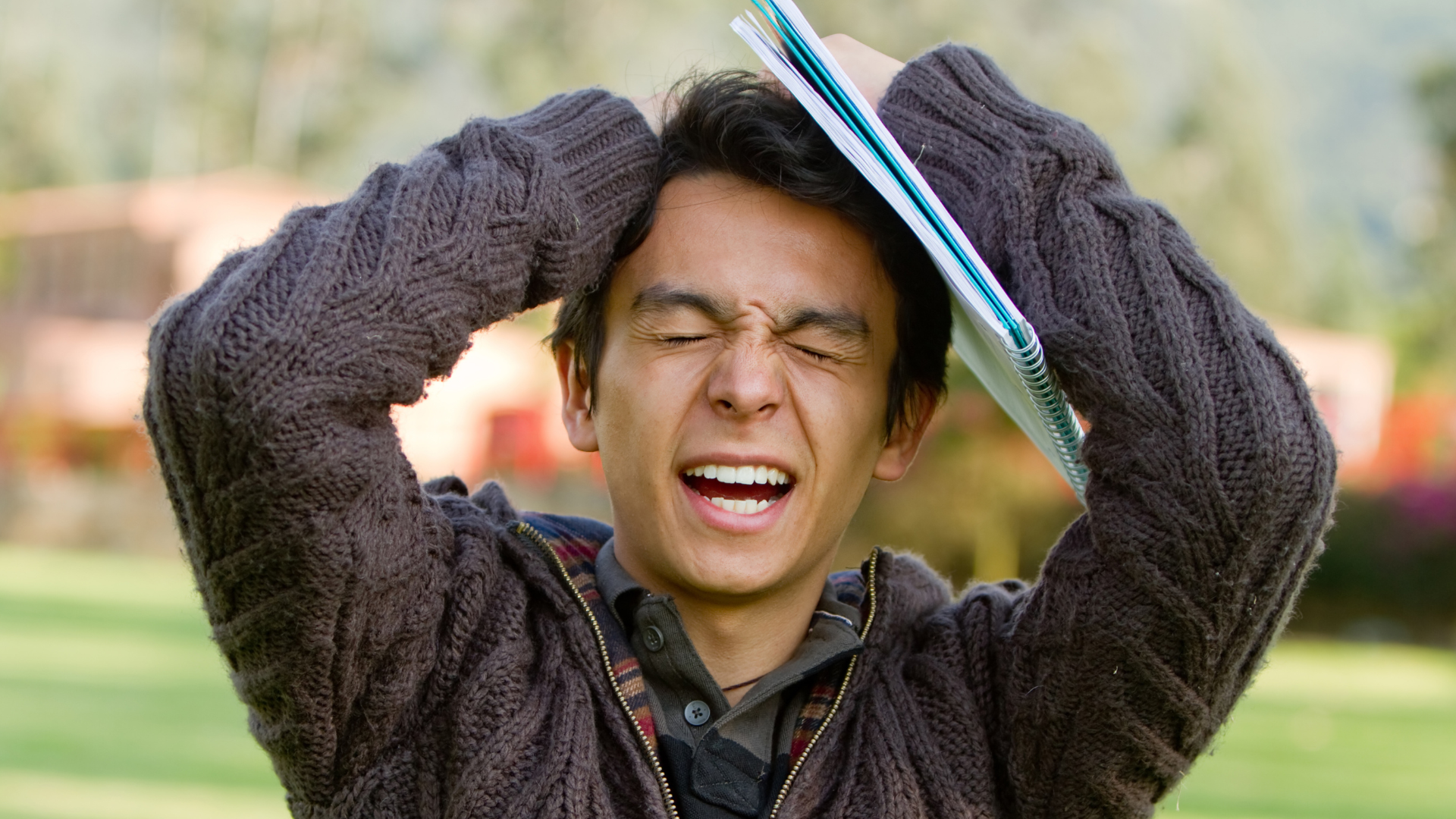 student with hands on their head