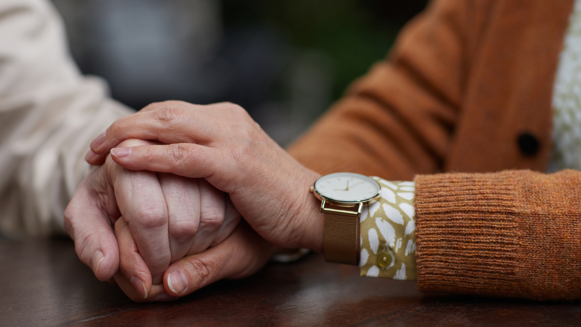 people holding hands supportively