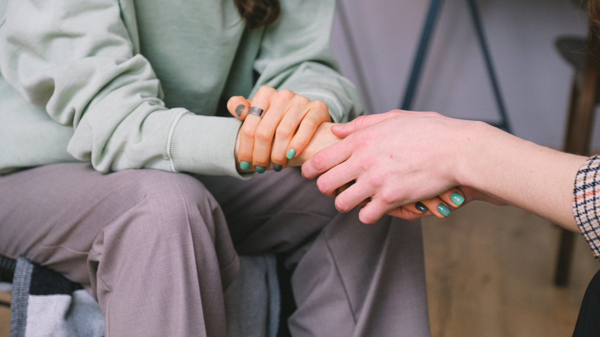 People holding hands supportively